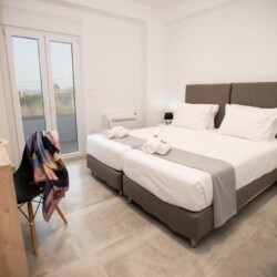 Cozy bedroom with two single beds and a desk for added convenience.