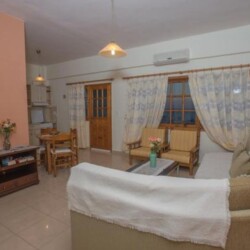 Living area with comfortable couch, sitting space, and sea view at Sunset Holiday Home, Neo Kalamaki